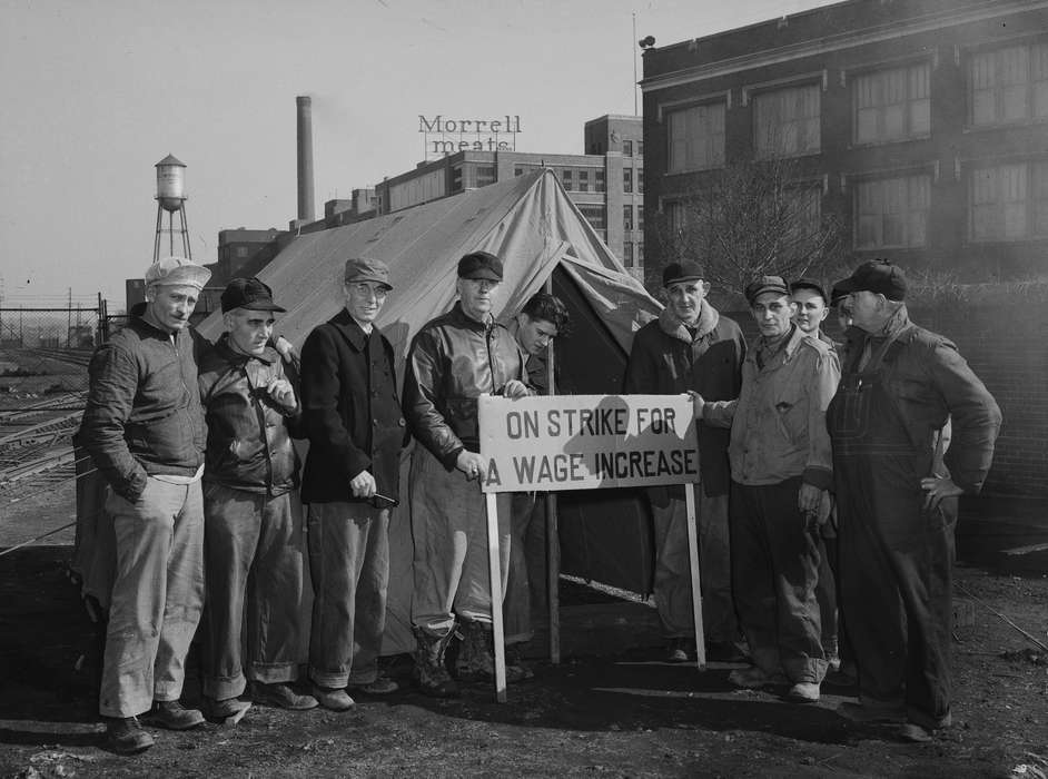 strike, Businesses and Factories, history of Iowa, Lemberger, LeAnn, meat packing plant, sign, tent, Civic Engagement, Portraits - Group, Iowa, Iowa History, Labor and Occupations, water tower, Ottumwa, IA