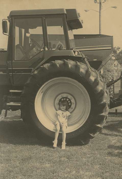 grass, outfit, Motorized Vehicles, Fairs and Festivals, Iowa, Children, correct date needed, Iowa History, smile, Waverly, IA, girl, Portraits - Individual, tractor, Waverly Public Library, history of Iowa