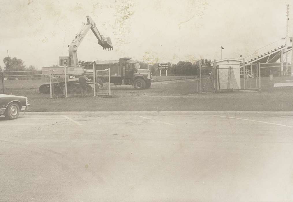 construction, Waverly Public Library, Iowa History, history of Iowa, Waverly, IA, Motorized Vehicles, bleacher, Labor and Occupations, man, correct date needed, Iowa, fence, track, parking lot