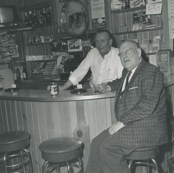 Leisure, can, beer, correct date needed, Iowa History, display, ashtray, wood paneling, suit, building interior, sign, clock, Iowa, Portraits - Group, barstool, cash register, Food and Meals, bar, glass, glasses, history of Iowa, Waverly Public Library, counter, Waverly, IA, man, Businesses and Factories