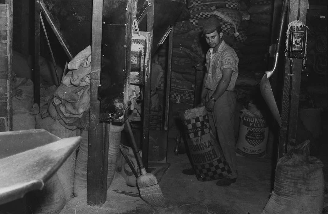 Businesses and Factories, Food and Meals, employee, history, Photos, Labor and Occupations, broom, Iowa, animal feed, IA, sacks, Portraits - Individual, United States, ia, purina, Coon Rapids Enterprise, historic, wrist watch, storage, Coon Rapids