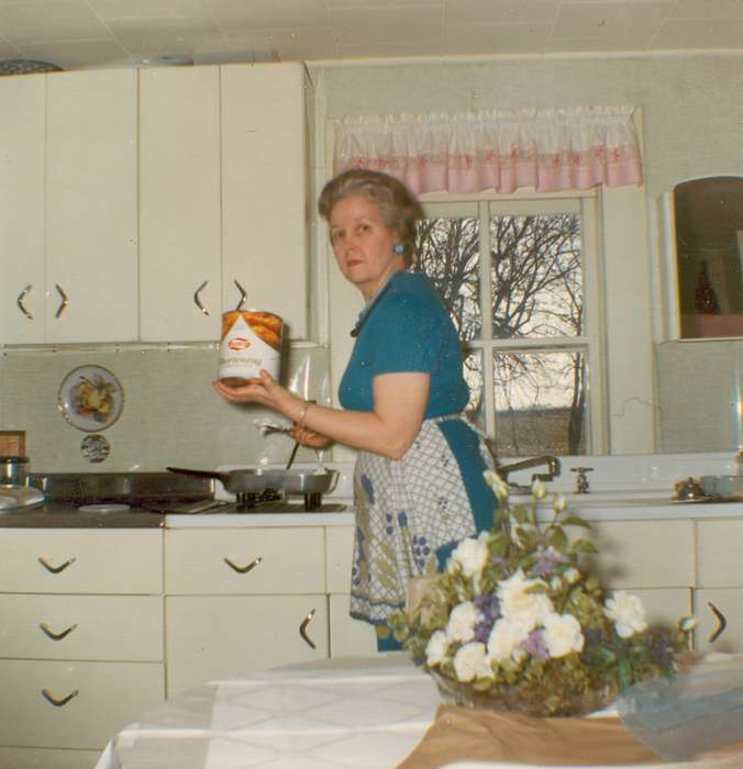 centerpiece, mid-century modern, flowers, cooking, history of Iowa, Portraits - Individual, Iowa, Iowa History, Food and Meals, kitchen, Fuller, Steven, woman, apron, Dike, IA