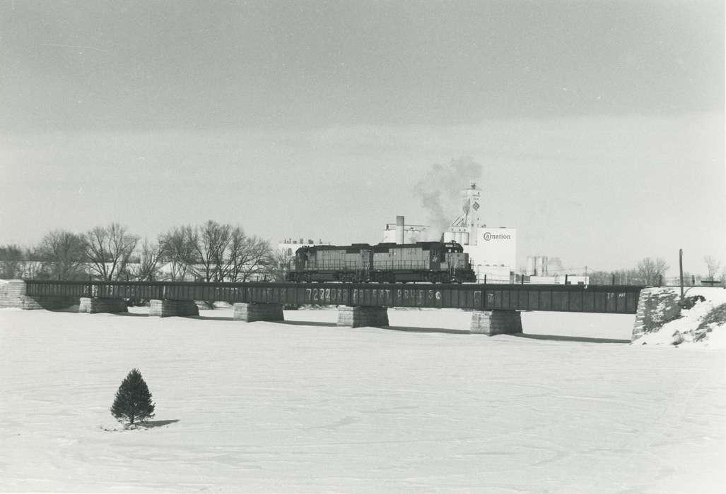 Landscapes, carnation, train, Winter, Businesses and Factories, Motorized Vehicles, winter, history of Iowa, Waverly, IA, Iowa, snow, factory, Waverly Public Library, train bridge, Iowa History