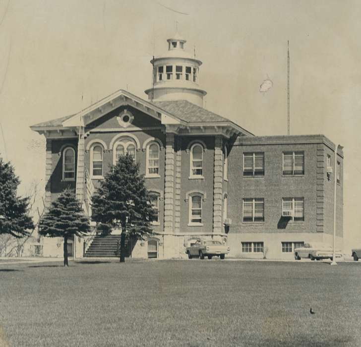 cars, brick building, american flag, correct date needed, Waverly Public Library, Iowa History, pine trees, Iowa, courthouse, Motorized Vehicles, history of Iowa