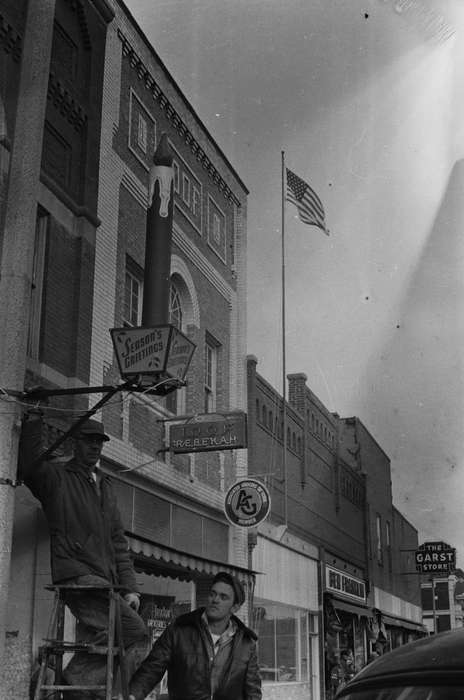 Businesses and Factories, storefronts, history, Holidays, Photos, winter coat, ladder, Iowa, IA, Cities and Towns, two men, United States, holiday, ia, Coon Rapids Enterprise, historic, american flag, Coon Rapids
