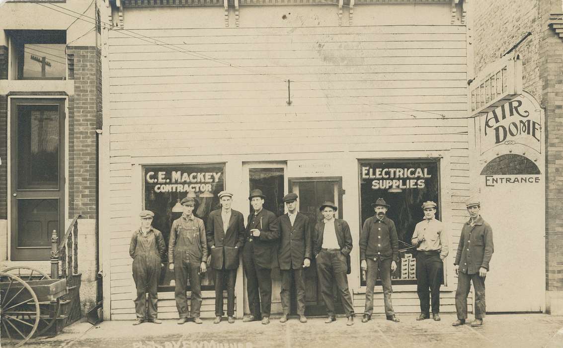 caps, e. bremer ave., Iowa History, door, hat, derby, wheel, Meyer, Mary, cap, wagon, suit, golf, fedora, overalls, Businesses and Factories, Iowa, history of Iowa, Main Streets & Town Squares, storefront, hats, Cities and Towns, men