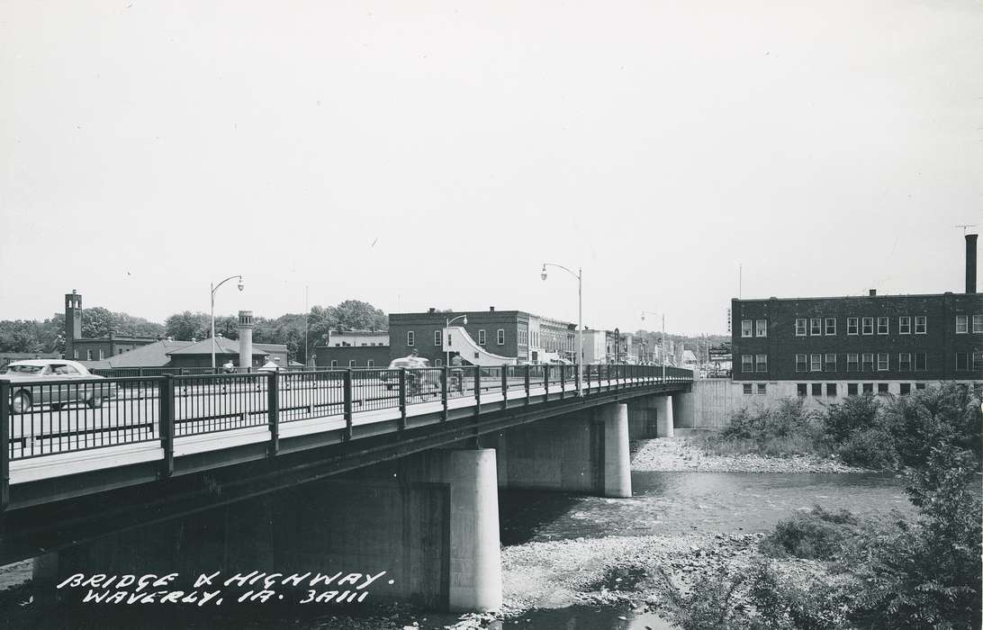 building, buildings, Meyer, Mary, Cities and Towns, Lakes, Rivers, and Streams, Main Streets & Town Squares, light, river, Iowa History, Iowa, bridge, street, fence, cedar river, history of Iowa