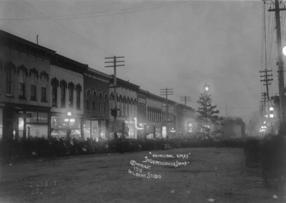 Families, Fairs and Festivals, mainstreet, Businesses and Factories, Winter, Entertainment, correct date needed, Iowa History, Cities and Towns, history of Iowa, dirt road, christmas, storefront, Main Streets & Town Squares, Iowa, streetlights, Library of Congress, Holidays