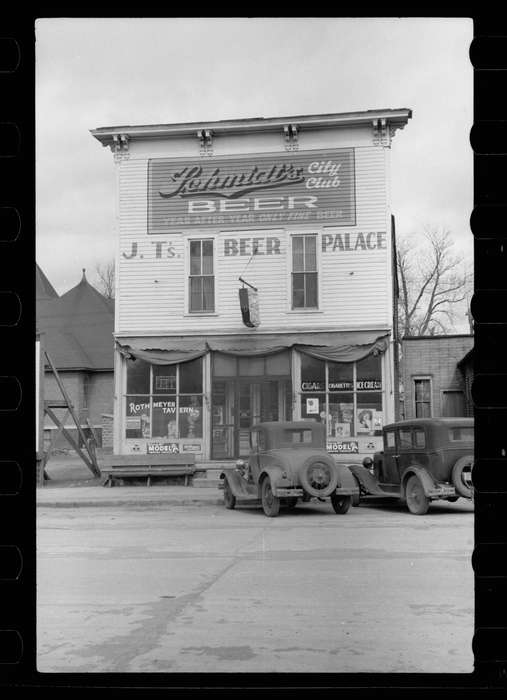 history of Iowa, Library of Congress, Iowa History, Businesses and Factories, Motorized Vehicles, cars, Iowa, Cities and Towns, storefront, bench, car, schmidt