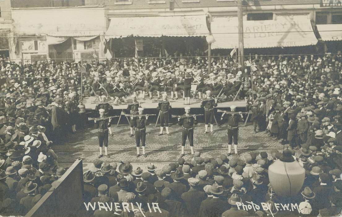 Fairs and Festivals, e. bremer ave., Iowa History, celebration, gathering, awning, Military and Veterans, Meyer, Mary, drill, band, military, concert, rifle, crowd, Iowa, history of Iowa, storefront, hats, Cities and Towns, navy