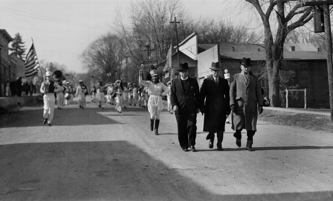 marching band, Entertainment, coat, telephone pole, Cities and Towns, dirt road, Melrose, IA, Lemberger, LeAnn, Iowa History, parade, Main Streets & Town Squares, fedora, Iowa, flag, history of Iowa