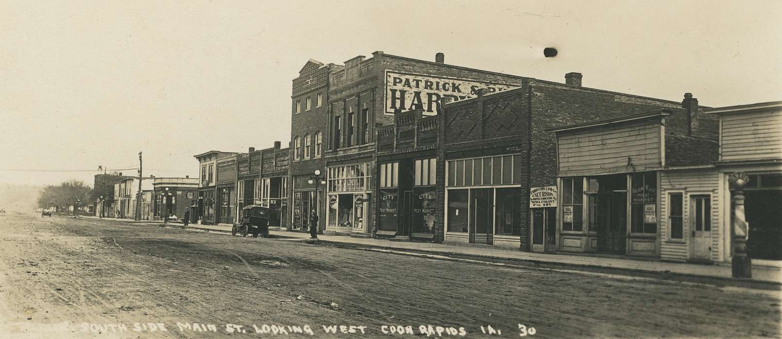 Motorized Vehicles, street lamp, correct date needed, Businesses and Factories, Cities and Towns, Coon Rapids Enterprise, dirt road, Portraits - Group, Main Streets & Town Squares, car, brick building