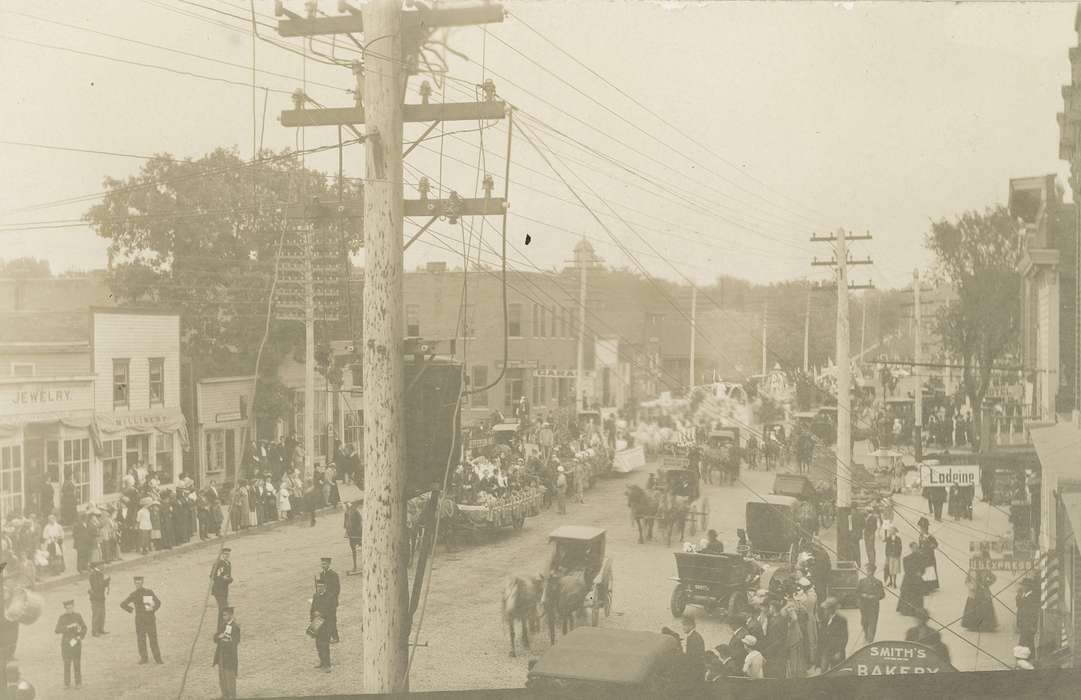 Fairs and Festivals, telephone line, e. bremer ave., marching, Iowa History, parade, Iowa, history of Iowa, Main Streets & Town Squares, carriage, float, power line, horse, storefront, Meyer, Mary, band, Cities and Towns