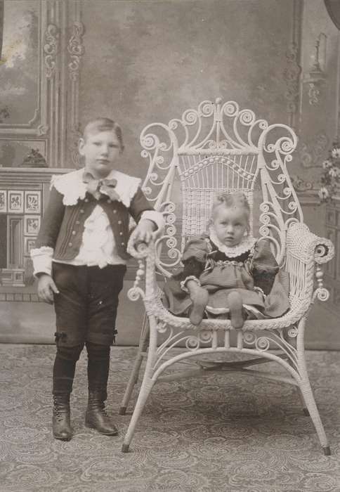 siblings, cabinet photo, Iowa History, Olsson, Ann and Jons, boy, history of Iowa, girl, little lord fauntleroy suit, Portraits - Group, Iowa, painted backdrop, child, New Hampton, IA, wicker chair, Children