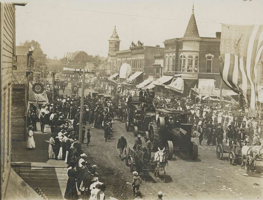 parade, electrical pole, Entertainment, banner, correct date needed, Cities and Towns, history of Iowa, Motorized Vehicles, american flag, Businesses and Factories, crowd, Iowa History, umbrella, brick building, Iowa, Waverly Public Library, Main Streets & Town Squares, Aerial Shots, horse, buggy, steam engine, clock tower, Animals, clock