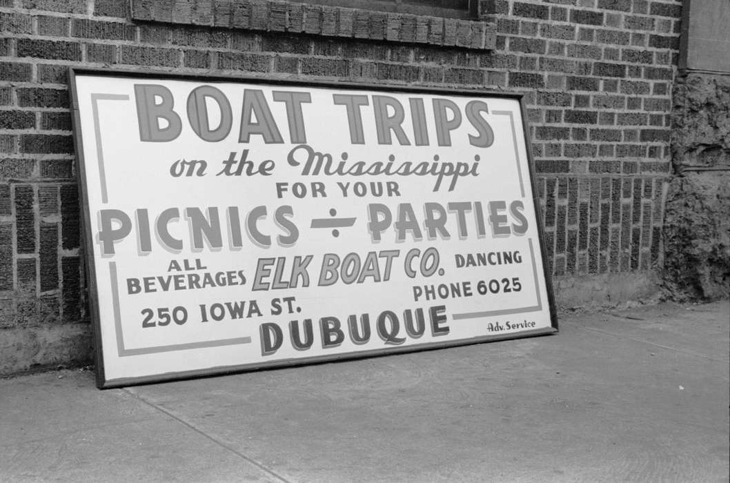 advertisement, Library of Congress, mississippi river, history of Iowa, sign, Cities and Towns, Iowa, Iowa History, boat trip advertisement, brick building, sidewalk