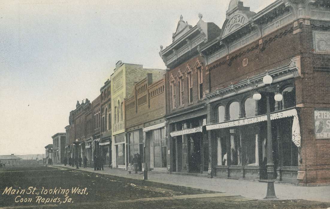 Cities and Towns, Coon Rapids Enterprise, dirt road, brick building, Portraits - Group, Main Streets & Town Squares, street lamp, Businesses and Factories