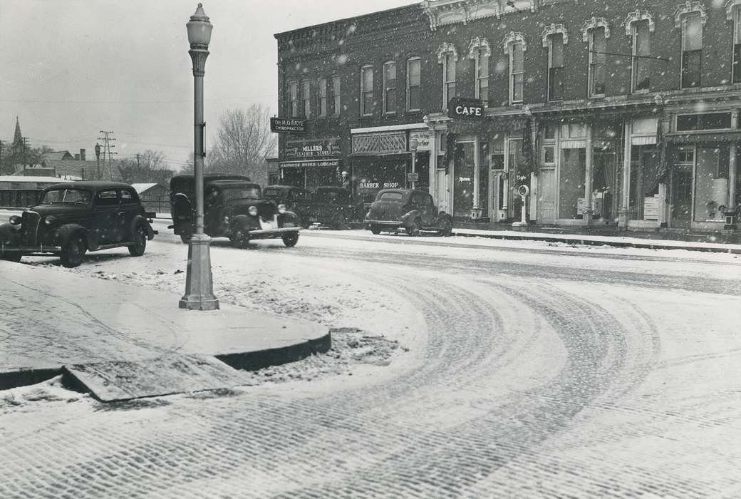 snow, lamp post, cafe, Motorized Vehicles, Main Streets & Town Squares, car, storefront, Iowa History, Waverly, IA, Waverly Public Library, Cities and Towns, barbershop, downtown, leather shop, Iowa, Businesses and Factories, street light, history of Iowa
