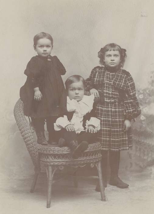 siblings, cabinet photo, Iowa History, brother, Council Bluffs, IA, Olsson, Ann and Jons, history of Iowa, little lord fauntleroy suit, Portraits - Group, Iowa, painted backdrop, child, sisters, wicker chair, Children