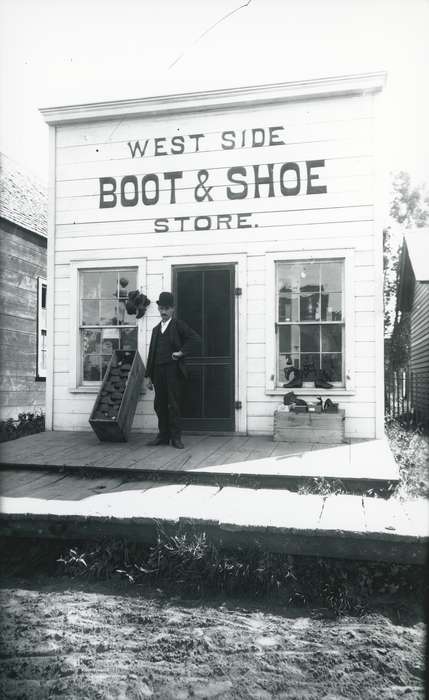 cobbler, Waverly Public Library, Labor and Occupations, wood sidewalk, Businesses and Factories, Cities and Towns, Main Streets & Town Squares, storefront, shoe store, Waverly, IA, Iowa History, dirt road, Iowa, history of Iowa