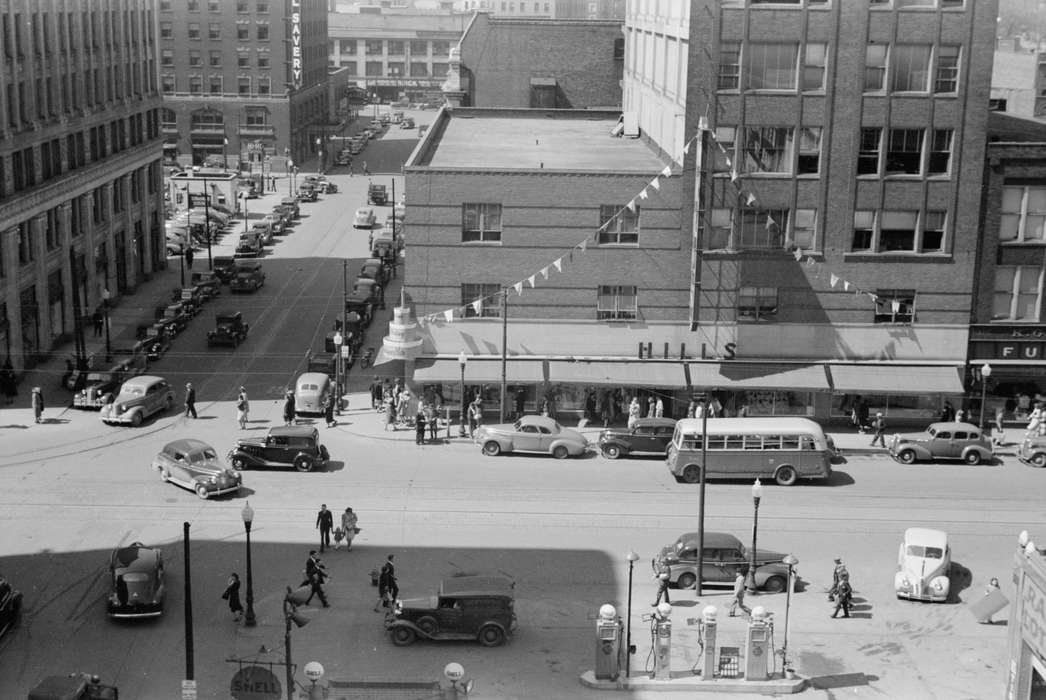 intersection, downtown, Cities and Towns, ford model a, Aerial Shots, pedestrian, bus, history of Iowa, Iowa History, street lamps, Businesses and Factories, Library of Congress, Motorized Vehicles, Portraits - Group, cars, downtown des moines, shell gas station, Iowa