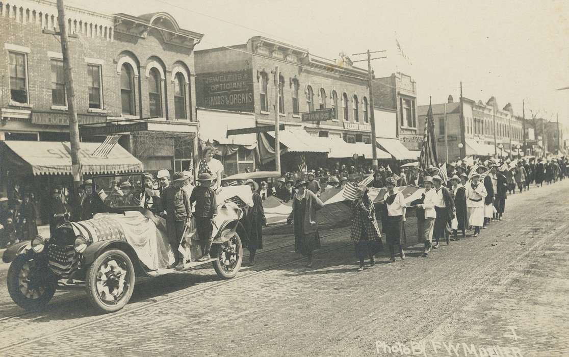 soldier, soldiers, Iowa History, flag, world war i, brick road, parade, awning, wartime, Military and Veterans, Meyer, Mary, world war 1, Motorized Vehicles, Civic Engagement, World War I, military, trolley tracks, crowd, Iowa, war, wwi, history of Iowa, Main Streets & Town Squares, storefront, Cities and Towns