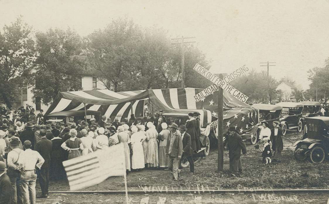 bowler, Iowa History, flag, world war i, hat, train track, wartime, Military and Veterans, Meyer, Mary, world war 1, bonnet, ivy cap, Motorized Vehicles, Civic Engagement, panama hat, crowd, homburg hat, Iowa, war, american, wwi, history of Iowa, train tracks, railroad crossing, Cities and Towns