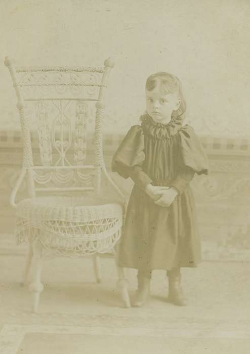 wicker chair, cabinet photo, Iowa History, history of Iowa, girl, Olsson, Ann and Jons, Iowa, Portraits - Individual, painted backdrop, State Center, IA, Children, ruffles