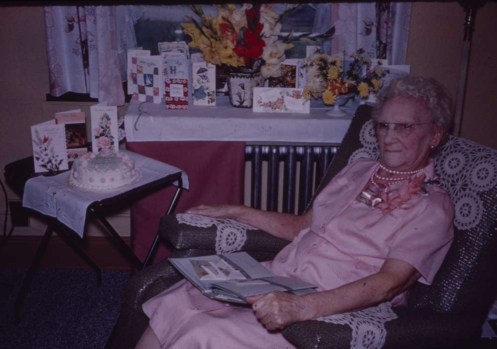 old woman, Portraits - Individual, Food and Meals, Iowa, flowers, dress, birthday cake, Homes, correct date needed, Iowa History, armchair, history of Iowa, Western Home Communities, table, necklace, cards