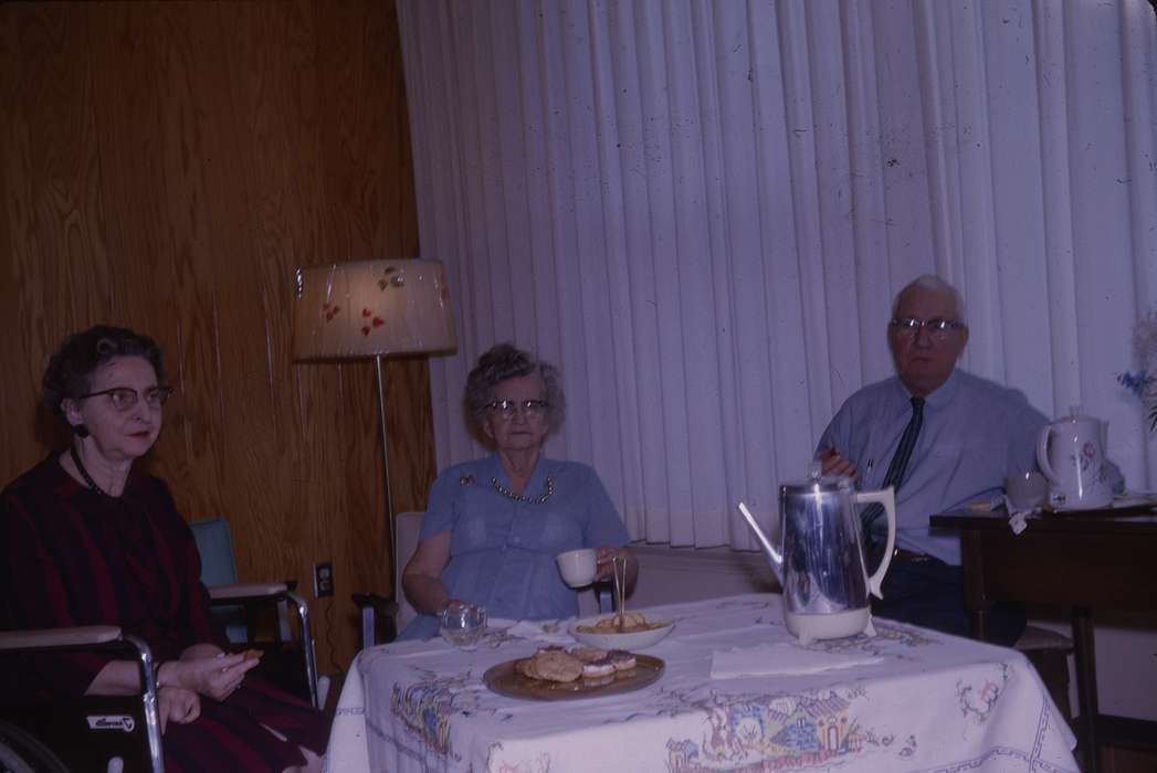old people, lamp, wheelchair, dress, tablecloth, Iowa History, earring, cookies, Food and Meals, Iowa, history of Iowa, table, elderly, table cloth, Western Home Communities, glasses, Portraits - Group, Leisure, necklace, mug