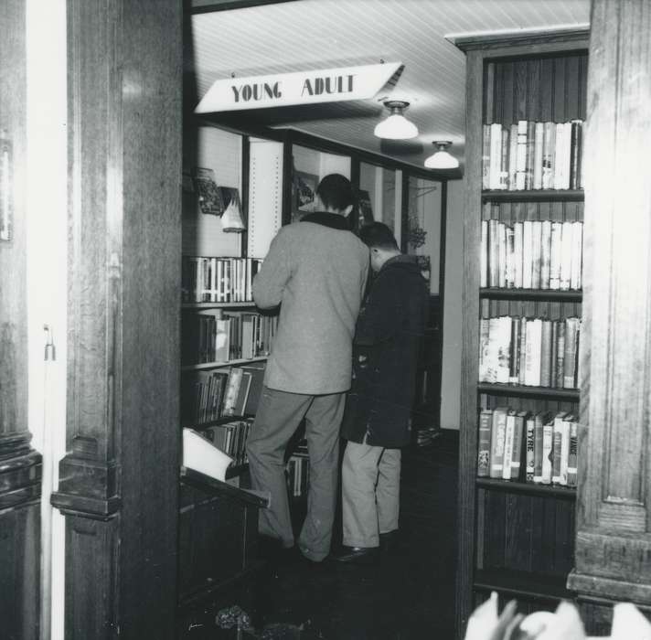 Waverly Public Library, young men, Schools and Education, Iowa History, bookshelf, library, books, Iowa, history of Iowa