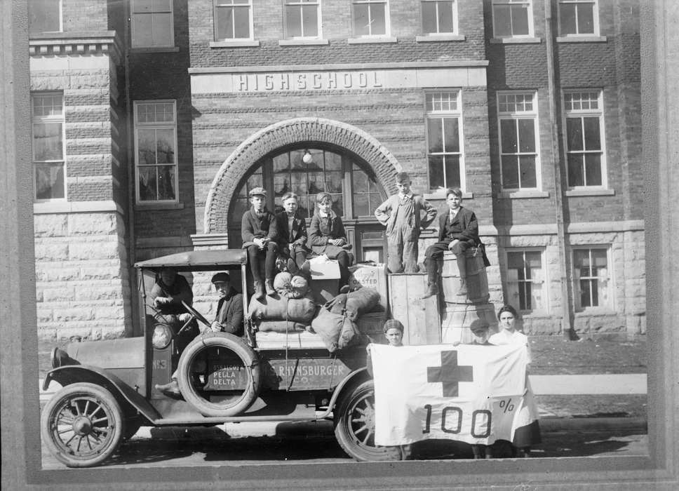 history of Iowa, Iowa History, Library of Congress, Civic Engagement, barrel, high school, truck, Motorized Vehicles, brick building, woman, Portraits - Group, men, Iowa, Children, red cross, boys, Schools and Education, Cities and Towns