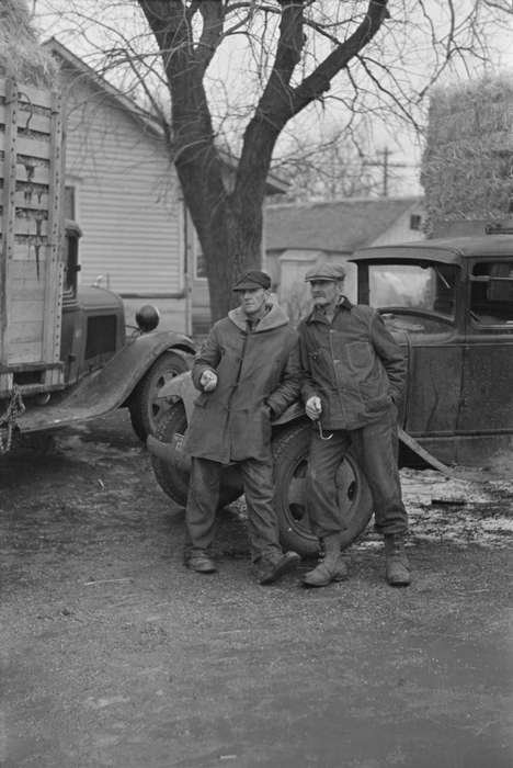 Cities and Towns, work clothes, square bales, hay truck, farmer, Library of Congress, Iowa History, Motorized Vehicles, Labor and Occupations, Farming Equipment, melting snow, tree, history of Iowa, Portraits - Group, Iowa, snow, man, hay bale