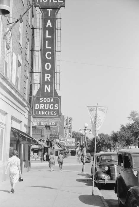 building exterior, Library of Congress, hotel, sidewalk, car, man, Iowa History, Businesses and Factories, Iowa, woman, history of Iowa, Main Streets & Town Squares, street light, street, Motorized Vehicles, Cities and Towns