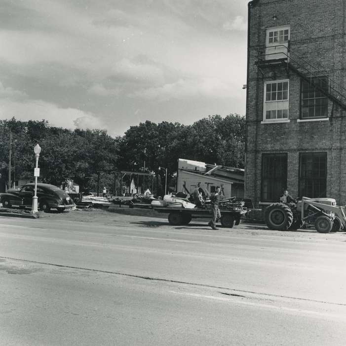 car, brick building, Iowa History, canning, flatbed trailer, Labor and Occupations, Iowa, workers, Businesses and Factories, street light, Waverly Public Library, history of Iowa, debris, Motorized Vehicles, correct date needed, Waverly, IA, tractor, street, Wrecks