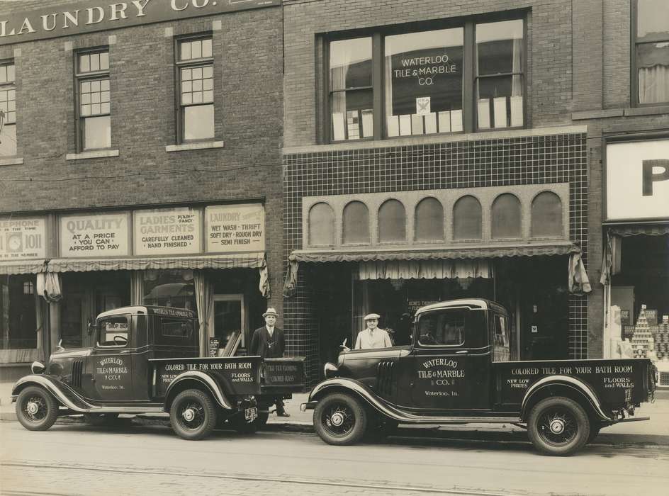 window, Iowa History, tire, wheel, wheels, tires, Motorized Vehicles, truck, windows, O'Brink, Lisa, panama hat, Businesses and Factories, Iowa, history of Iowa, Main Streets & Town Squares, storefront, trucks, newsboy cap, Labor and Occupations, Cities and Towns, men