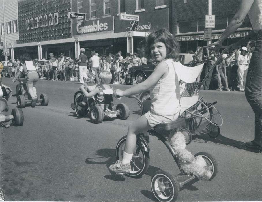 Civic Engagement, Outdoor Recreation, Waverly, IA, parade, Leisure, history of Iowa, Main Streets & Town Squares, brick building, store, Fairs and Festivals, main street, Waverly Public Library, Iowa History, tricycle, Iowa, children, general store, Entertainment, Children
