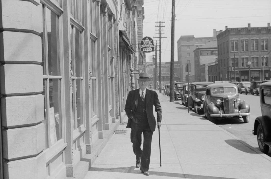 sidewalk, Portraits - Individual, chevrolet, Library of Congress, Iowa, handsome, Iowa History, history of Iowa, suit, Cities and Towns, car, spiffy, cane, man, Businesses and Factories, tie