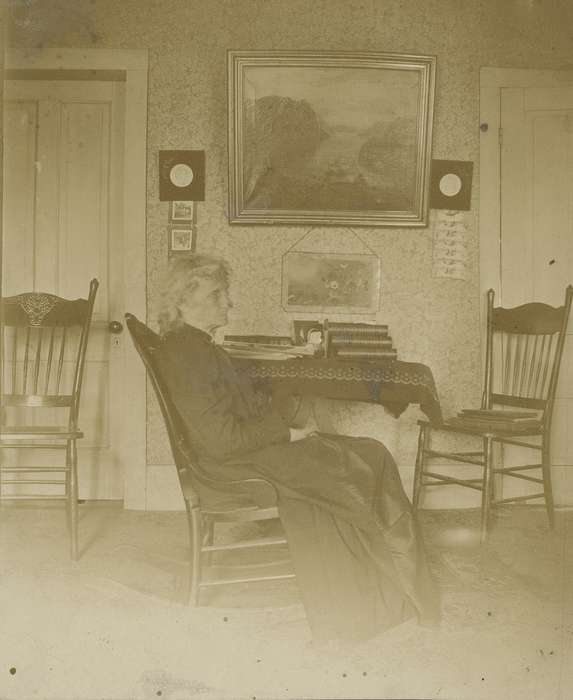painting, rocking chair, Homes, book, tablecloth, Waverly Public Library, rug, Portraits - Individual, Iowa History, chair, wallpaper, table cloth, Waverly, IA, old woman, Iowa, history of Iowa