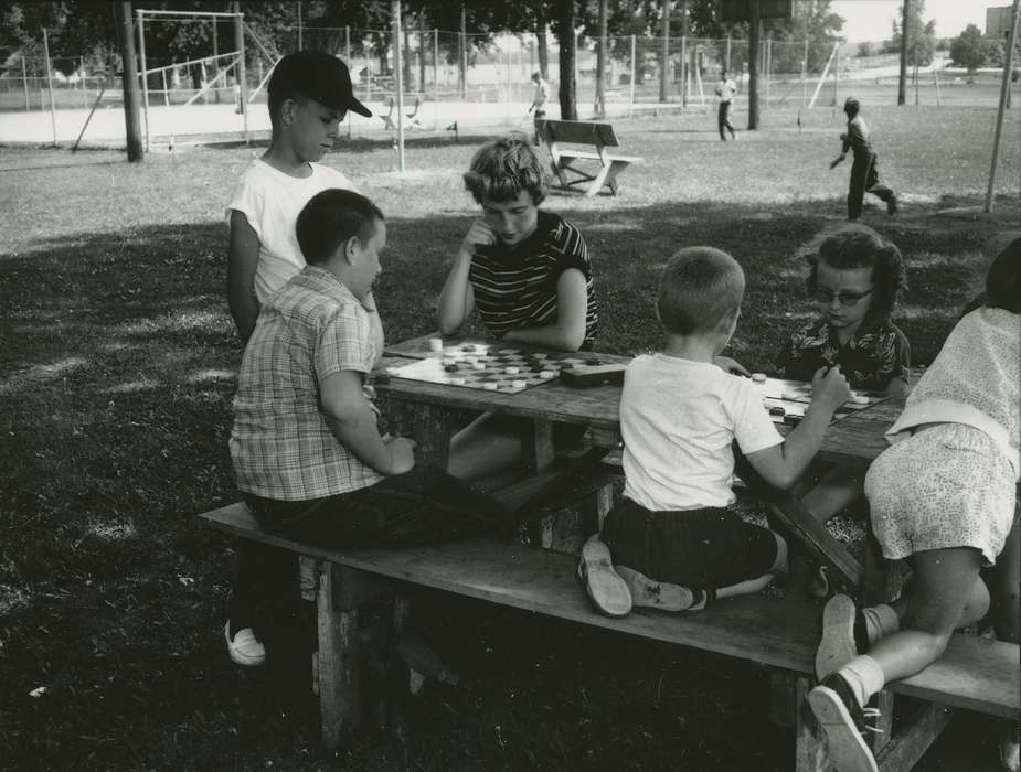 Waverly Public Library, park, checkers, Iowa History, history of Iowa, Leisure, baseball cap, picnic bench, glasses, picnic table, Children, Iowa, fence