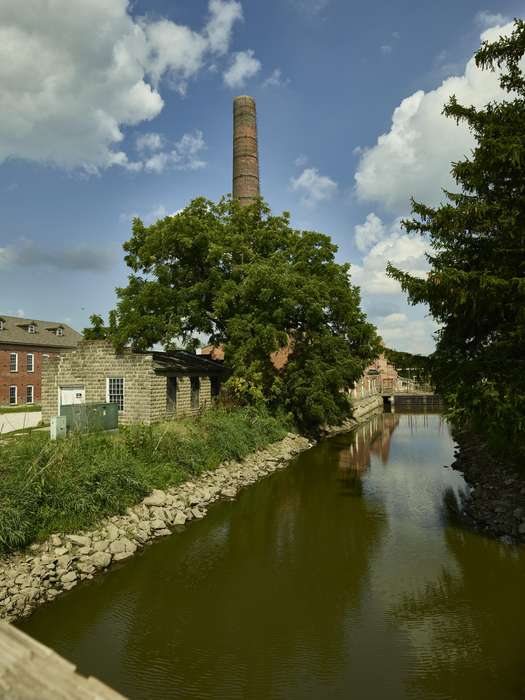 Businesses and Factories, history of Iowa, bridge, Library of Congress, Cities and Towns, creek, smokestack, brick, Lakes, Rivers, and Streams, retaining wall, trees, spillway, river, canal, Iowa, Iowa History, smoke stack