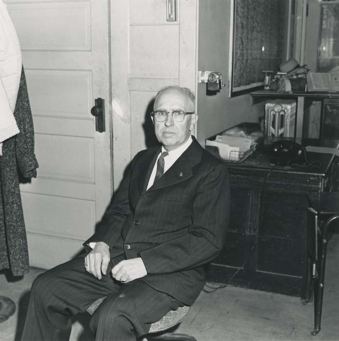 Portraits - Individual, Waverly, IA, office chair, Iowa, Waverly Public Library, desk, hat, suit, correct date needed, Iowa History, glasses, history of Iowa, businessman, man, pencil sharpener, telephone, fettkether, radiator