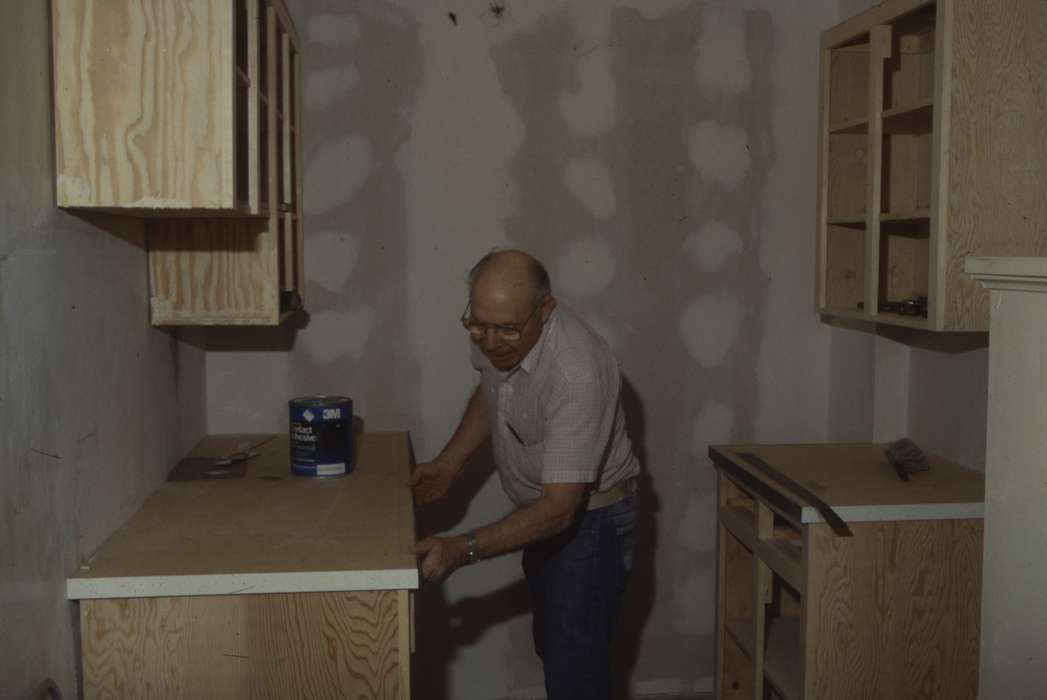 Homes, kitchen, Western Home Communities, old man, wall, Iowa History, paint can, outfit, Iowa, countertop, installation, history of Iowa, cupboard, Labor and Occupations