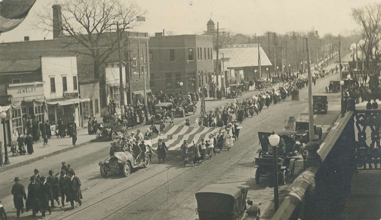 Waverly Public Library, Cities and Towns, Iowa History, military, history of Iowa, Businesses and Factories, american flag, Main Streets & Town Squares, Motorized Vehicles, Military and Veterans, Civic Engagement, flag, military parade, Waverly, IA, main street, car, Iowa