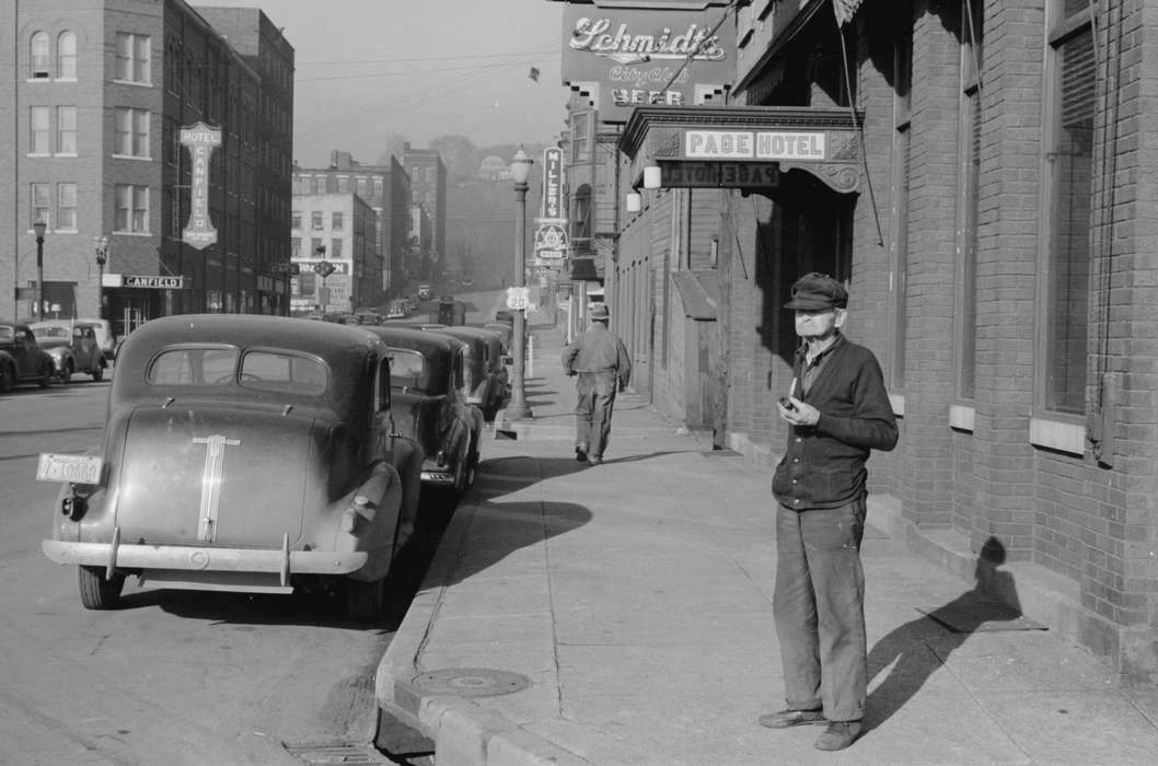 storefront, Cities and Towns, brick building, hotel, street corner, Iowa History, Motorized Vehicles, Main Streets & Town Squares, Leisure, mainstreet, history of Iowa, old man, Iowa, street parking, Library of Congress, tobacco pipe, Businesses and Factories