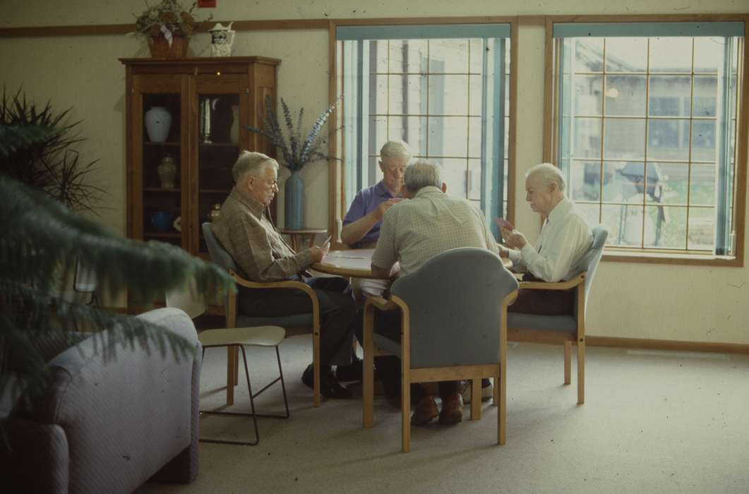 old people, table, window, outfit, elderly, men, Homes, Iowa History, card game, display case, chairs, Western Home Communities, rubber plant, glasses, Iowa, Leisure, history of Iowa