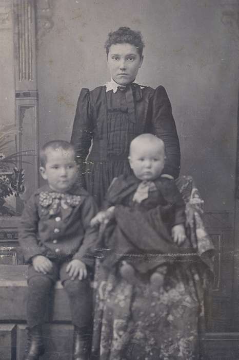 woman, Olsson, Ann and Jons, high buttoned shoes, painted backdrop, siblings, Children, Iowa, Families, Iowa History, ribbon, cabinet photo, frizzy bangs, Marble Rock, IA, Portraits - Group, boy, history of Iowa