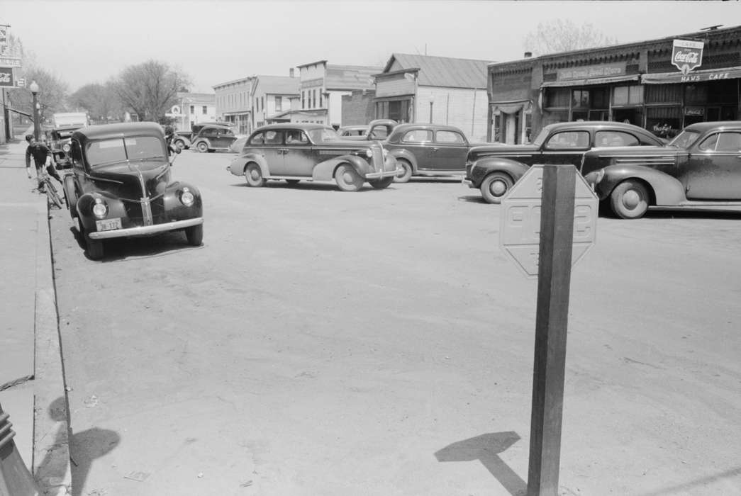 Library of Congress, Iowa History, Businesses and Factories, street parking, Iowa, dirt road, history of Iowa, cars, Main Streets & Town Squares, storefront, mainstreet, Motorized Vehicles, Cities and Towns