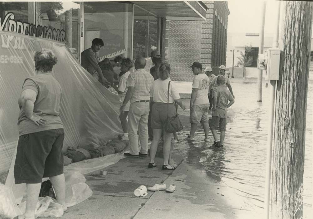 Cities and Towns, piano, Businesses and Factories, Children, Waverly Public Library, sandbag, Floods, Iowa History, sandbagging, music store, Portraits - Group, tarp, Waverly, IA, Iowa, hard hat, history of Iowa, Labor and Occupations