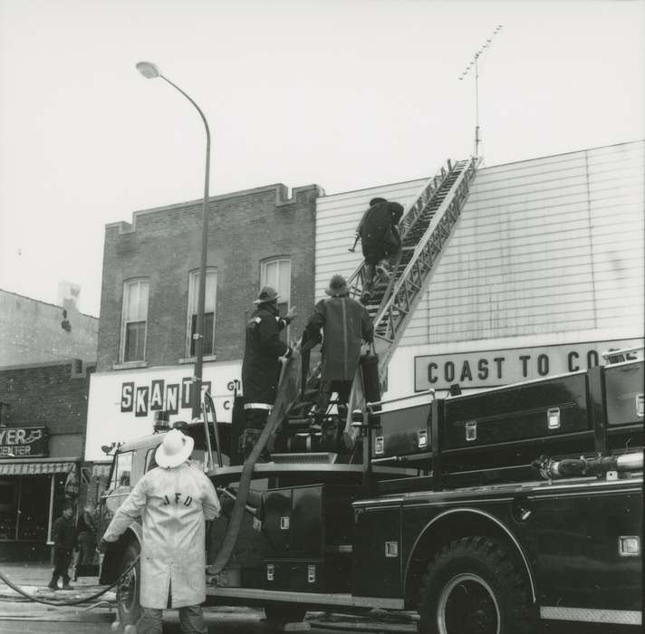 ladder, Wrecks, Motorized Vehicles, Main Streets & Town Squares, hardware store, Iowa, fireman, Iowa History, gift shop, Waverly, IA, Cities and Towns, Waverly Public Library, Labor and Occupations, fire truck, Businesses and Factories, history of Iowa